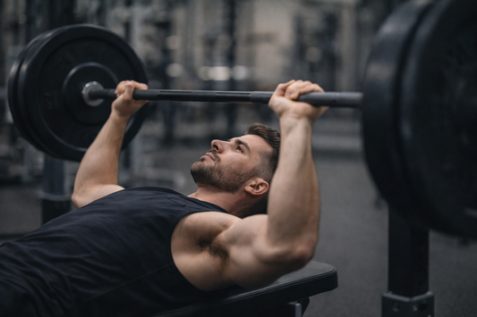 Focused lifter performing a controlled bench press rep to demonstrate autoregulated training and proper technique