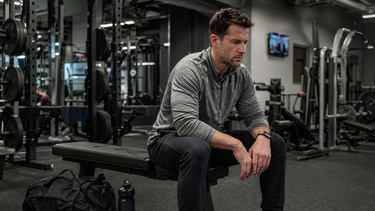 Natural lifter reviewing a workout plan in the gym after work