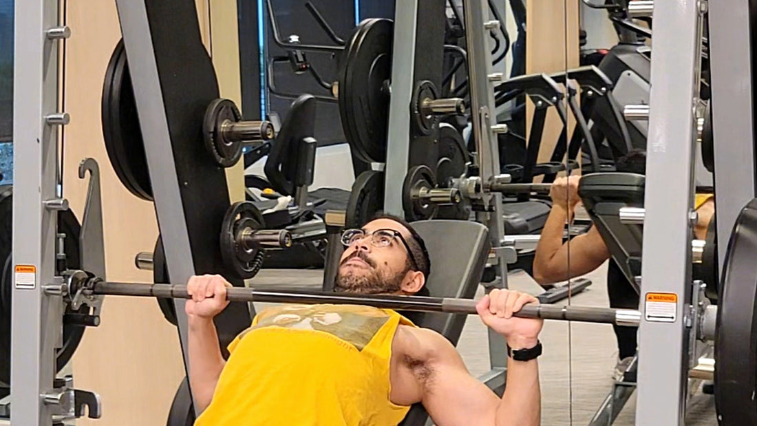 Ray performs an incline Smith-machine press in a gym during a hypertrophy workout.